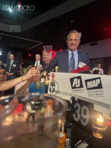 Titan 100 Event 6 | AJ Adhesives Andy Schwartz celebrating at the AJ Adhesives & MId-America Packaging table.